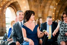 a group of people sitting next to each other in front of a man and woman