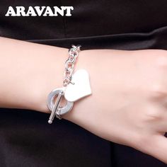 Product Features: The Aravant 925 Silver Heart Bracelet Chain features an intricately crafted heart design, exuding timeless elegance and sentiment. Crafted from premium 925 sterling silver, the bracelet ensures durability, tarnish resistance, and a lustrous finish. Equipped with a secure clasp, the bracelet ensures a snug and worry-free wear. Ideal for daily wear or special occasions, the bracelet complements various styles and outfits. The heart design symbolizes love and affection, making thi Elegant Heart-shaped Wedding Charm Bracelet, White Gold Heart Charm Bracelet For Anniversary, White Gold Heart Bracelet With Charm For Anniversary, Elegant Heart-shaped Charm Bracelet For Weddings, Elegant White Gold Charm Bracelet For Valentine's Day, Elegant White Gold Chain Bracelet For Valentine's Day, Elegant Wedding Charm Bracelet With Heart Charm, Elegant White Gold Charm Bracelet For Mother's Day, Elegant Sterling Silver Bracelet For Valentine's Day