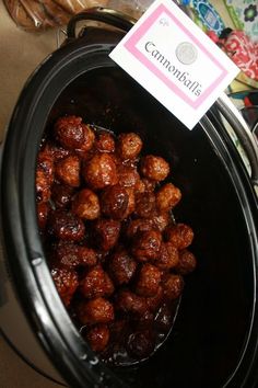 a close up of food in a crock pot with a label on the lid