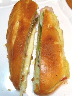 a sandwich cut in half sitting on top of a white plate