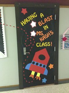 a door decorated with a rocket ship and stars