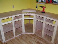 an unfinished kitchen with yellow walls and wood flooring is being built into the wall