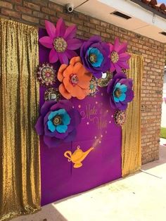 a purple door decorated with paper flowers and gold sequins for a mardi gras party