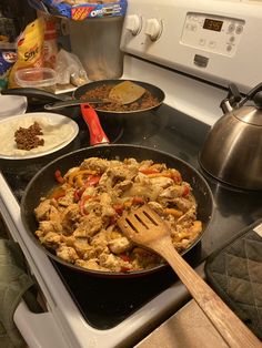 a pan filled with food sitting on top of a stove