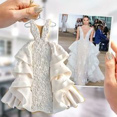 a woman holding up a white wedding dress