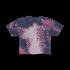 a tie dyed t - shirt with pink and blue colors on the front, against a black background