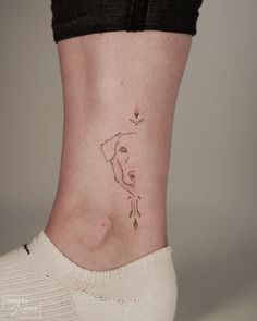 a woman's lower leg with a small tattoo on her left side ribcage