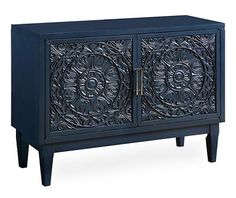 an ornate black cabinet with two doors