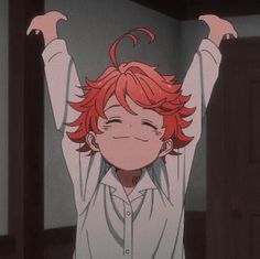 an anime character with red hair raising his arms in the air