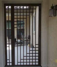 an iron gate is open on the outside of a house