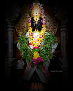 the statue is decorated with flowers and leaves