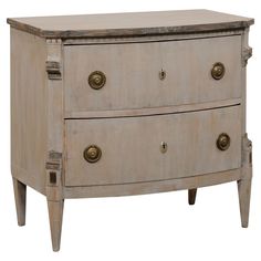 an old chest of drawers with brass knobs on the top and bottom, against a white background