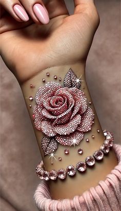 a woman's arm with a rose tattoo on it, and diamonds around the wrist