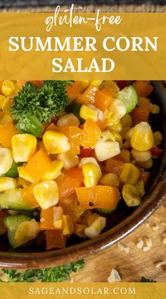 a bowl filled with corn and vegetables on top of a wooden table