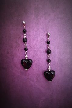 Add a touch of dark elegance to your look with these gothic long dangle earrings. Featuring a striking black heart and black beads hanging delicately from silver links, these earrings are the perfect accessory for anyone with a flair for the dramatic. Make a statement with these unique and stylish earrings that are sure to turn heads wherever you go. Perfect for adding a hint of mystery and allure to any outfit, these earrings are a must-have for any gothic jewelry collection. Each product is on Gothic Style Single Earring As Gift, Gothic Single Earring As Gift, Affordable Handmade Gothic Earrings, Gothic Dangle Pierced Earrings, Gothic Black Heart-shaped Earrings, Gothic Earrings, Heart Dangle Earrings, Long Dangle Earrings, Stylish Earring