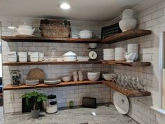 the shelves in the kitchen are filled with dishes