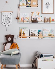 a child's room with bookshelves, toys and pictures on the wall