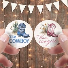 two hand holding badges that say team cowboy and team cowgirl, with lights in the background