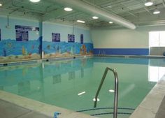 an indoor swimming pool with no people in it