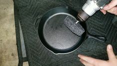 someone is using an electric drill to clean a frying pan