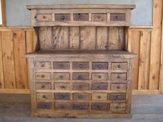 an old wooden dresser with many drawers