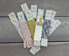 several crocheted headbands with tags attached to them on a wooden surface