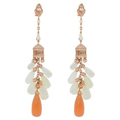 A mesmerizing moonstone chandelier collection inspired by the architectural chandeliers in Indian palaces. These are playful earrings which elegantly dangle, they have been accented with fancy color gems to bring a sparkle to the intricate design. Orange and white moonstone earrings in 18K rose gold with diamond, morganite, spessartite, pink pearls, and white pearls. White Moonstone: 52.92 carats, drop shape, 12 pieces. Orange Moonstone: 28.15 carats, drop shape, 2 pieces Morganite: 4.00 carats, Indian Palaces, Orange Gem, Moonstone Earrings, Colored Gems, Pink Pearl, Rose Gold Diamonds, Morganite, Chandelier Earrings, 18k Rose Gold