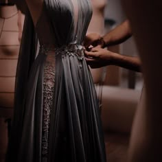 a woman in a dress is being worked on