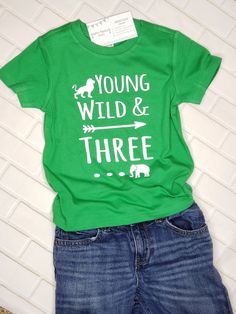 "When it comes to celebrating a 3rd birthday, a plain ol' shirt will never do! If your soon-to-be three year old is totally loveable but slightly wild? Does he LOOOOVE jungle animals? Then this \"Young Wild & THREE\" shirt will be a perfect match for your lil guy! ------------------------------------------------------------- 3rd Birthday shirt: All shirts are short-sleeve and fit true-to-size (boutique brand) - Long-sleeve shirts are available by special order. Please contact us before order Green Graphic Print T-shirt For First Birthday, Green T-shirt With Letter Print For First Birthday, Green Casual Top For First Birthday, Green Short Sleeve Top For First Birthday, Playful Green T-shirt For Birthday, Birthday Letter Print Green Shirt, Green Short Sleeve Shirt For Birthday, Third Birthday Boys, 3rd Birthday Shirt