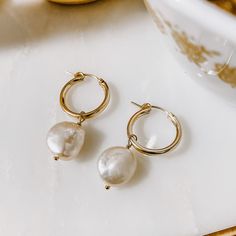 These ultra comfy 14k Gold Fill hoops are classic in style and feature a hinge closure. A freshwater Pearl coin dangles effortlessly from these 19mm hoops making the perfect classy "everyday" earring. All Derive Jewelry is hypoallergenic and nickel free. Modern Pearl Charm Earrings For Everyday, Modern Everyday Earrings With Pearl Charm, Classic Huggie Jewelry With Pearl Charm, Timeless Hypoallergenic Hoop Earrings For Everyday, Timeless Everyday Hypoallergenic Hoop Earrings, Classic Dangle Hoop Earrings With Pearl Charm, Everyday Hoop Jewelry With Pearl Charm, Teardrop Huggie Earrings With Pearl Charm, Everyday Round Hypoallergenic Pearl Earrings