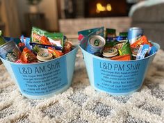 two blue buckets filled with food sitting on top of a rug