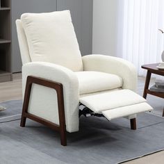 a white recliner chair sitting on top of a rug