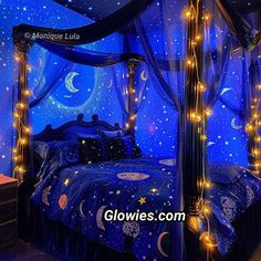 a canopy bed with stars and moon lights on it