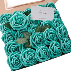 a box filled with blue roses sitting on top of a table