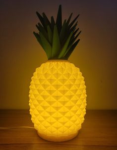 a yellow pineapple lamp sitting on top of a wooden table