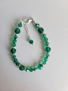 "This bracelet is made with a new Swarovski crystal color, Majestic Green, 6mm/8mm round crystal with 6mm Clear AB rondelle crystal. The remainder of the beads and the findings are sterling silver. It has a 1\" extension with a beaded drop making it adjustable. Custom Orders are always welcome! Ask about free sizing." Elegant Nickel-free Crystal Bracelet With Round Beads, Sterling Silver Crystal Bracelet With Round Beads, Sterling Silver Crystal Bracelet With Spacer Beads, Silver Crystal Bracelets With 8mm Beads, Silver Crystal Bracelets With Beads, Elegant Faceted Czech Glass Bracelets, Elegant Faceted Czech Glass Bracelet, Faceted Round Bead Bracelets For May Birthstone, Faceted Round Beads Bracelet For May Birthstone