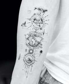 a person with a tattoo on their arm that has an image of the earth and sun