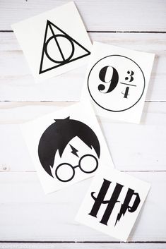 three harry potter stickers on top of a white wooden table next to each other