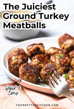 a white plate topped with meatballs next to a fork