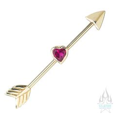 an arrow with a heart shaped stone on it's end is shown in gold