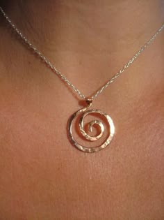 SIZE: Medium Pendant 1 1/4" x 1"  (16" or 18") will come in 16" unless specifiedThis small spiral pendant is inspired by the graceful spirals of the nautilus. Each spiral is hand shaped, hammered with my signature textured from my antique anvil. The texture comes from years of history, transferring every nick, dent and cranny which is transferred to the metal with every hammer strokeGreat for every day, this small spiral pendant hangs from a delicate sterling chain with spring clasp and daisy lo Copper Pendant Necklace, Hand Forged Spiral Jewelry Gift, Spiral Wire Wrapped Sterling Silver Necklace, Unique Spiral Sterling Silver Necklace, Spiral Hand Forged Sterling Silver Jewelry, Silver Spiral Copper Jewelry, Unique Spiral Sterling Silver Jewelry, Nickel-free Sterling Silver Swirl Necklace, Symbolic Spiral Sterling Silver Jewelry