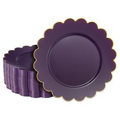 purple plates with gold rims are stacked next to each other on a white background