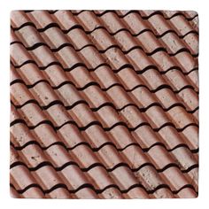 an old tile roof with wavy tiles on the top and bottom, in brown tones