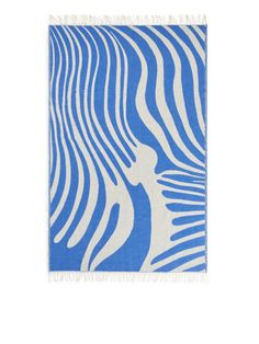 a blue and white zebra print rug with fringes