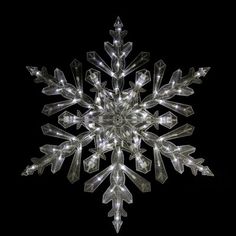 an illuminated snowflake is shown in the dark