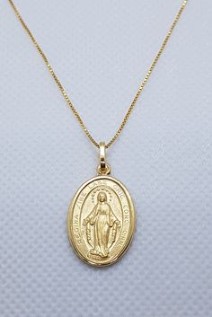 Silver plated gold Miraculous Medal Necklace. The necklace and pendants are made of 925 sterling silver plated with gold . Perfect for everyday wear. You can choose different types of chains and pendant size! Gold Oval Charm Necklace In Sterling Silver, Gold Oval Sterling Silver Charm Necklaces, Gold Plated Oval Necklace With Charms, Gold Oval Charm Necklaces In Sterling Silver, Gold Oval Sterling Silver Charm Necklace, Elegant Miraculous Medal Necklace, Spiritual Gold Plated Necklaces With Miraculous Medal, Elegant Miraculous Medal Pendant Necklace, Gold Miraculous Medal Pendant Necklace