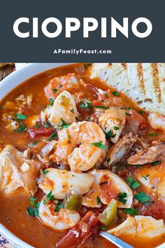 a white bowl filled with shrimp and tomato soup