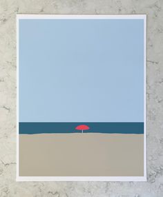 a red umbrella sitting on top of a beach under a blue sky