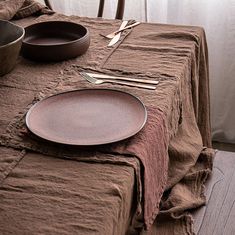 a table set with plates, silverware and utensils on top of it