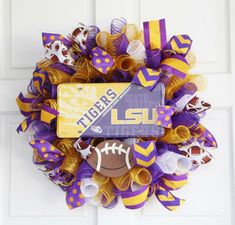 the lsu wreath is decorated with purple, yellow and white footballs